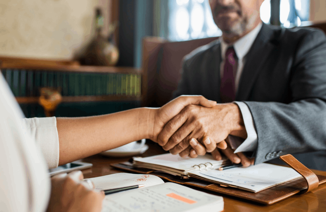 two persons shaking hands